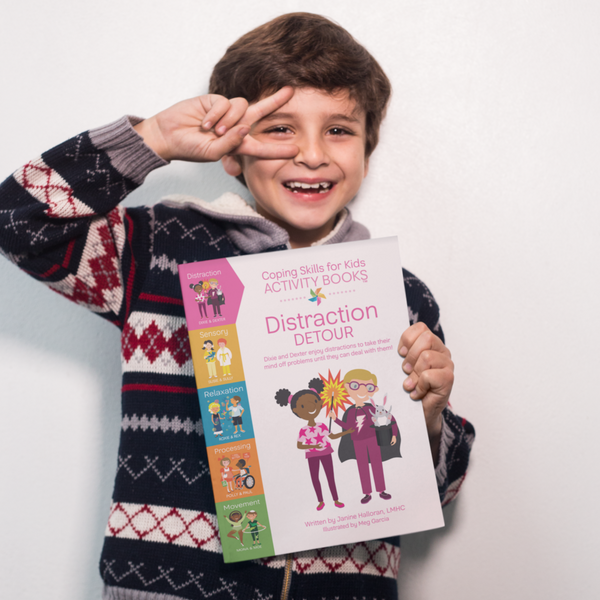 Boy Holding Distraction Detour Activity Book